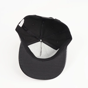 Detail view of the cap interior featuring white sweatband, care label and adjustable strap