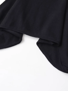 Close-up of black knitted fabric texture showing flat stitch detail and clean hem edges