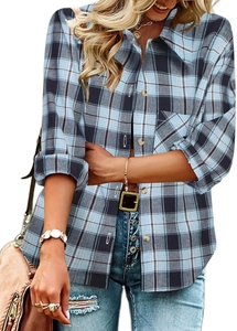 Detailed close-up of blue and grey plaid pattern and button-up cuff on long sleeve shirt