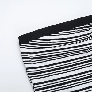 Close-up of black and white striped knit fabric texture with ribbed knit structure