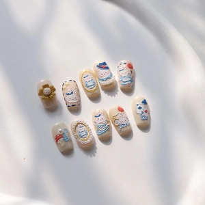 Detail of 3D embossed nail stickers featuring blue rabbit and forest fairytale designs
