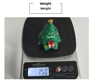 Top view of a resin Christmas tree ornament on an electronic scale weighing 150g