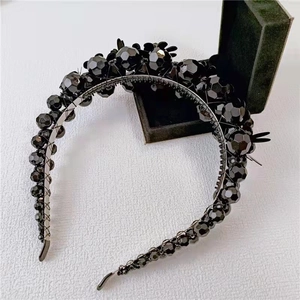 Detailed view of handmade black crystal beaded headband with shimmering faceted pearls
