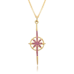 Detail of gold starburst necklace pendant with pink crystals and smooth reflection