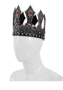 Macro detail of gothic royal crown with red gemstones and antique black metal scrollwork