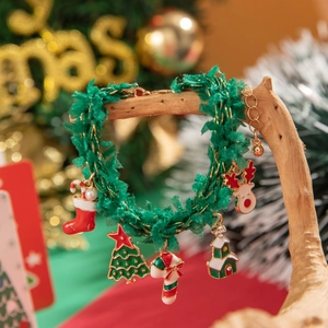Detailed view of Christmas charm bracelet with colorful beads and festive holiday pendants