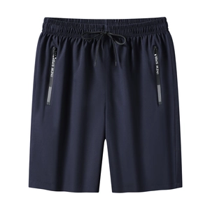 Detail of dark navy gym shorts featuring elastic drawstring waist and secure zip pockets