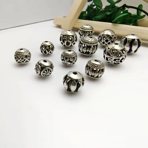 Collection of hollow silver alloy beads with vintage ethnic floral and geometric patterns