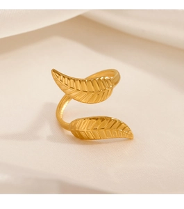 Close-up of 18K gold plated leaf ring showing detailed veins on warm satin fabric