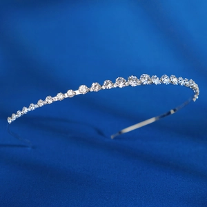 Silver thin headband with sparkling round crystals on a premium textured navy background