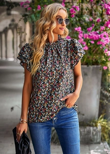 Close-up of floral print blouse featuring high neckline and ruffle sleeve details