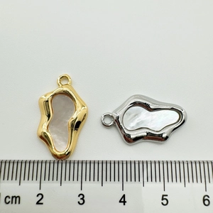 Detailed macro view showing the 2cm size scale of shell heart pendant jewelry charms