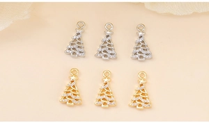 Detailed view of silver and gold Christmas tree pendants with cubic zirconia inlay