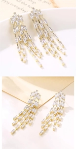 Detailed macro of gold tassel earrings featuring tiered rectangular cut clear crystals