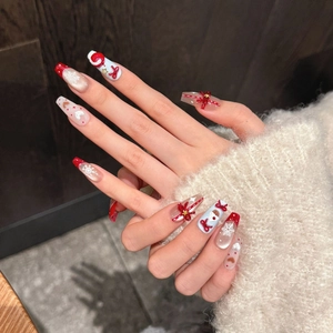 Christmas red and blue press-on nails with 3D Santa, bow, and snowflake charms
