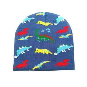 Close-up of tight knit texture and colorful dinosaur jacquard patterns on blue beanie