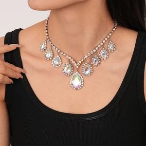 Detail view of a luxury teardrop pendant necklace with sparkling AB crystals on a model