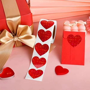 Detail of red heart-shaped adhesive seal stickers on gift box with festive packaging