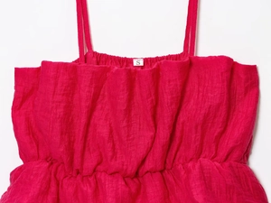 Détail du caraco plissé rouge rose montrant la texture du tissu et l'étiquette S