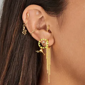 Detail of 18K gold-plated earring set with lightning bolt, snake charm, and long chain tassel