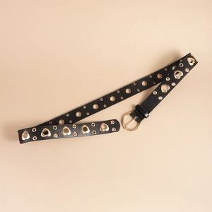 Detail of black leather belt with gold round buckle and heart shaped eyelets