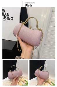 Detail of pink crystal evening bag with golden metal handle and sphere clasp