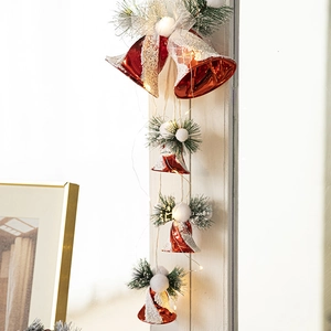 Christmas hanging red bells with LED lights and pine needles for holiday window decoration