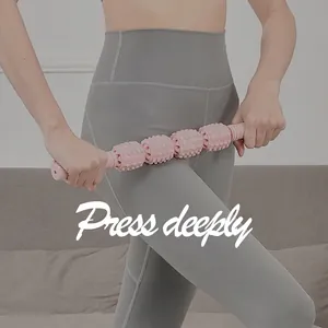 Pink foam roller massage stick with four-wheel deep tissue spikes for leg muscle recovery