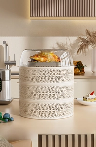 Three-tier stackable hollow food covers with a transparent top lid on a kitchen counter