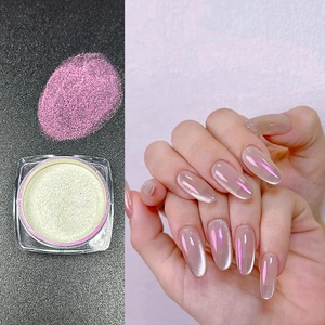 Macro shot of iridescent aurora nail powder showing white powder and pink purple effect