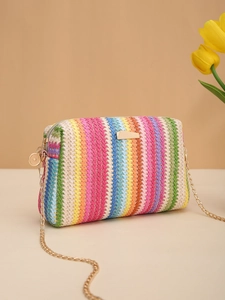Detail of colorful rainbow straw camera bag featuring gold chain and metallic plate