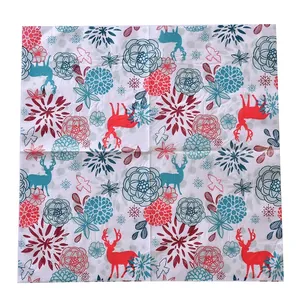 Close-up of square holiday napkins featuring festive reindeer and snowflake patterns