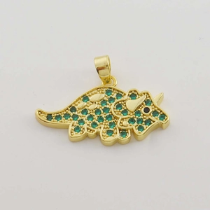 Macro detail of triceratops pendant with gold plating and green zircon micro-inlay