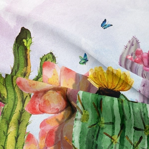 Detailed macro view of bohemian tapestry showing watercolor cactus and floral prints