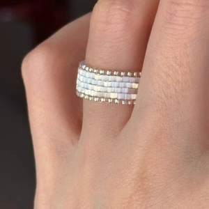 Handmade woven bead ring featuring white tubes and champagne gold beads in a wide band