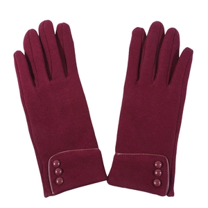 Detail view of burgundy fleece gloves featuring three decorative buttons on the wrist cuff