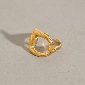 Macro shot of 18k gold plated stainless steel D-shape open ring on grey background