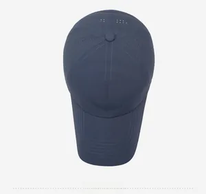 Detail view of navy blue baseball cap showing laser-cut ventilation holes and NOROS logo