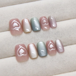 Handmade cat eye press-on nails set with 3D heart textures on velvet jewelry tray