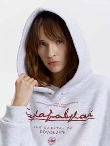 Dettaglio della stampa frontale su una felpa con cappuccio oversize grigio chiaro