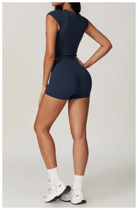 Rear view of navy blue high-waist fitness shorts and tight short-sleeved yoga top