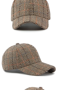 Detailed macro view of vintage brown plaid pattern and textured fabric on baseball cap