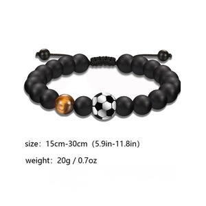 Close-up of adjustable soccer bead bracelet with matte black beads and tiger eye stone