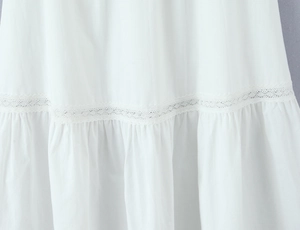 Close-up of white lace patchwork and fine pleated details on French style fabric