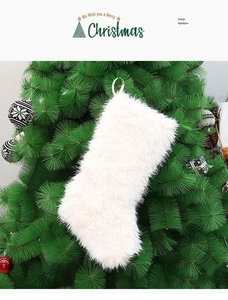 Detail of plush white faux fur Christmas stocking hanging on a green festive tree
