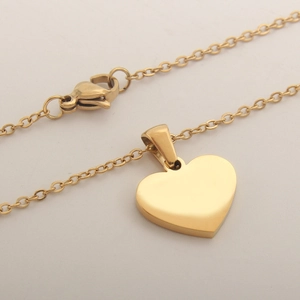 Golden heart-shaped pendant necklace with white shell inlay on a delicate chain