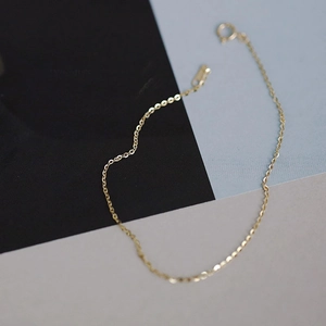 Close-up of minimalist 14k gold plated 925 silver thin chain with spring clasp detail