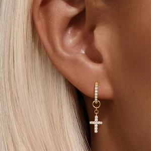 Close-up of gold-plated S925 silver hoop earrings with diamond-encrusted cross pendant