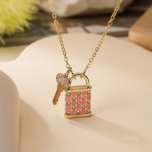 18K gold plated necklace featuring pink checkered lock and crystal heart key charms