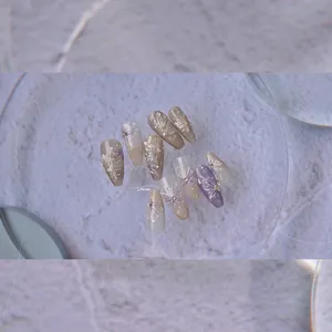 Macro detail of long coffin press-on nails with 3D purple butterflies and pearls